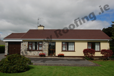  bungalow house with a new coat of roof paint applied to faded roof slates 