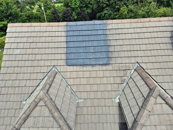 roof with paint improperly applied to it in patches