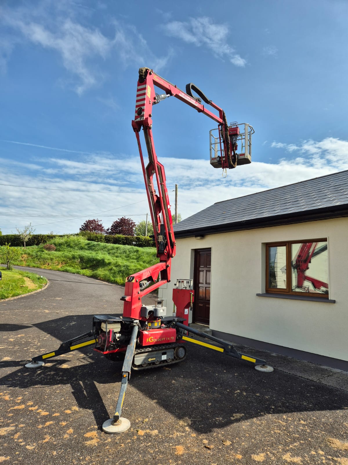A lift being used to clean roof tiles.