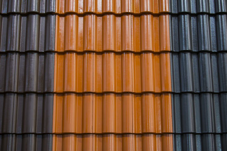 Roof tiles being cleaned and primed before painting